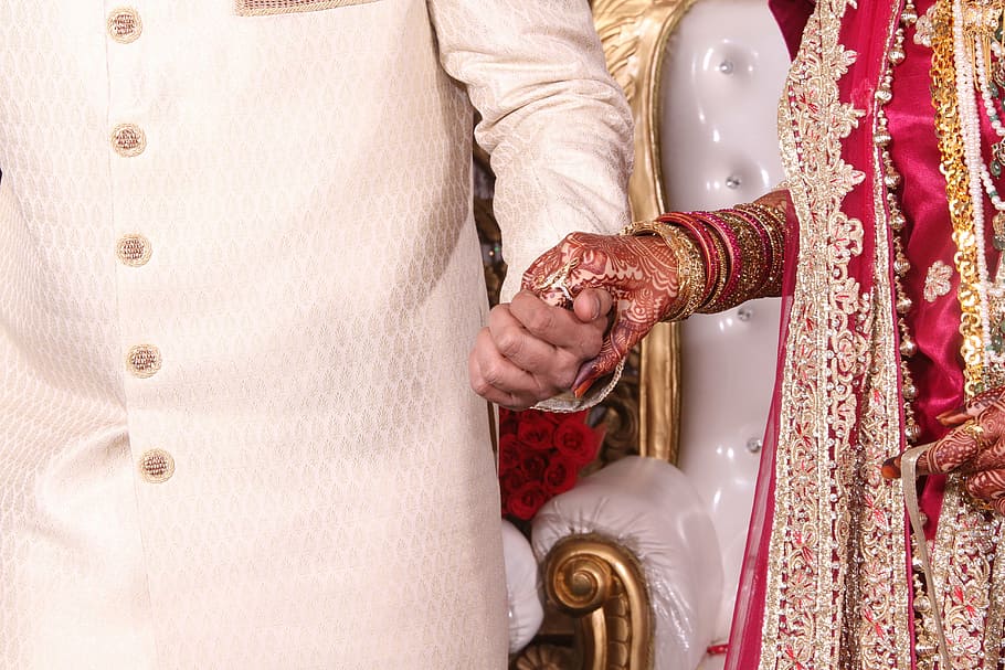man holding hand of woman, couple, indian, wedding, indian couple