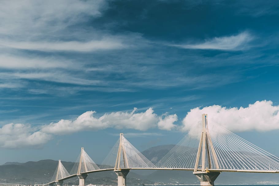 white cantilever bridge under blue sky, white suspension bridge near mountains HD wallpaper
