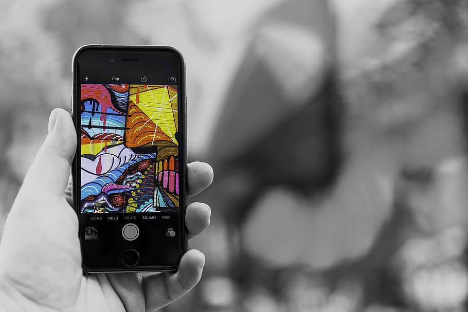 person holding iPhone displaying graffiti painting, smartphone HD wallpaper