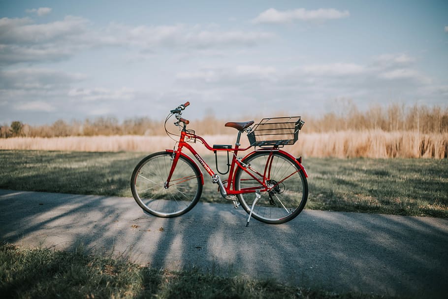 red commuter bike on road in between grass field during daytime, red commuter's bike HD wallpaper