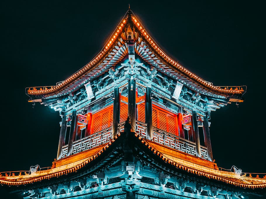 lighted pagoda temple at night time, teal and beige temple, neon