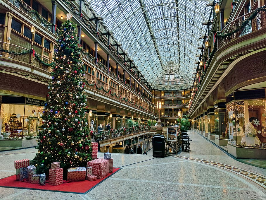 state of the art building interior with lit Christmas tree, Christmas tree surrounded by gift boxes inside building HD wallpaper