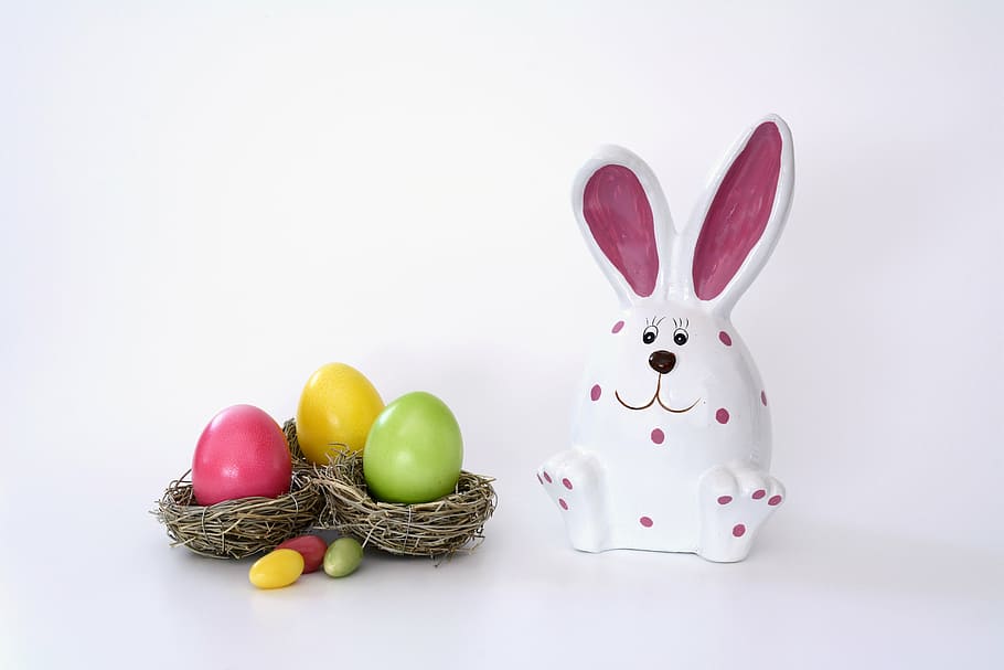 white and pink rabbit ceramic figurine beside Easter eggs, easter nest HD wallpaper