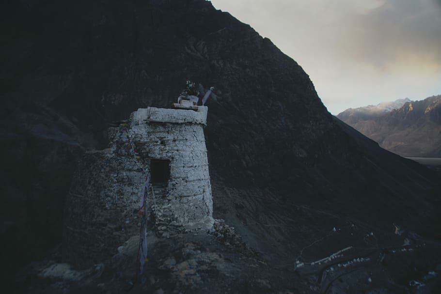 concrete house near mountain at daytime, silhouette photo of concrete dungeon on mountain HD wallpaper