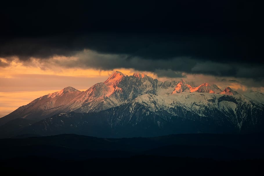 landscape photography of snow mountains under nimbus clouds, mountain covered with snow under cloudy sky HD wallpaper