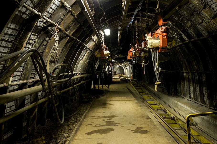 photo of tunnel with orange electric hoist hanging on the ceiling HD wallpaper