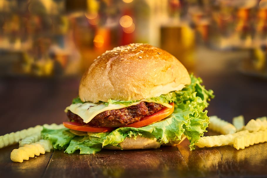 shallow focus photography of hamburger with tomato, lettuce, and cheese beside bunch fried fries, HD wallpaper