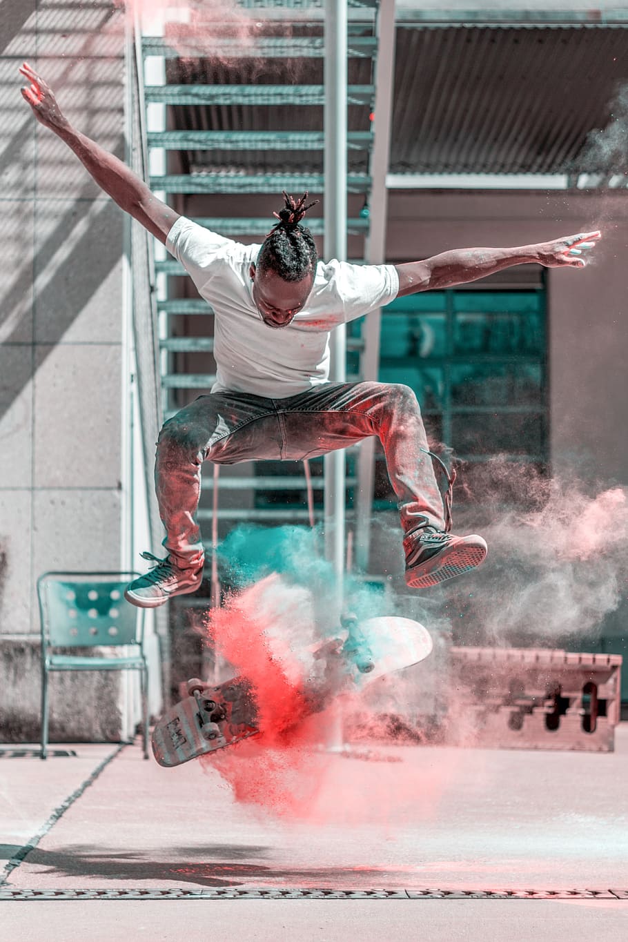 man doing flip trick with skateboard and smoke, skateboarder