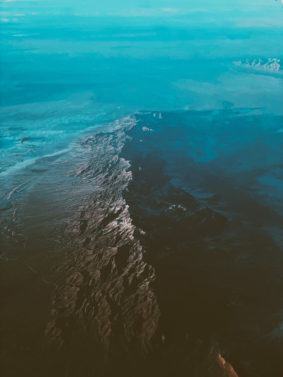top view of ocean, aerial view of mountains beside osue, rock