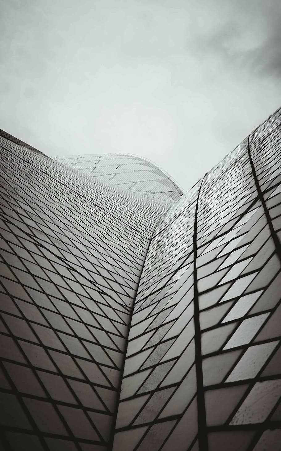 grayscale photography of black and white building low angle photography, curtain wall building under white sky HD wallpaper