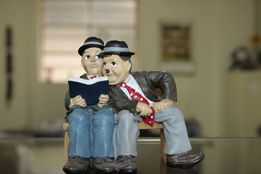 man sitting beside man while holding book, i flip flap, reading HD wallpaper