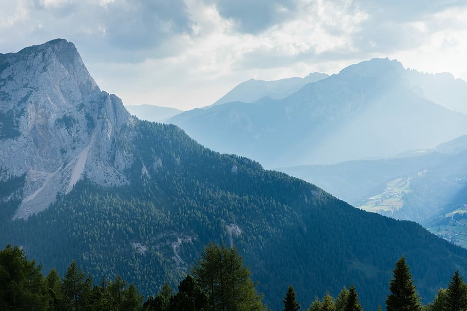 photography of mountain, mountain field with trees under cloudy sky during daytime HD wallpaper