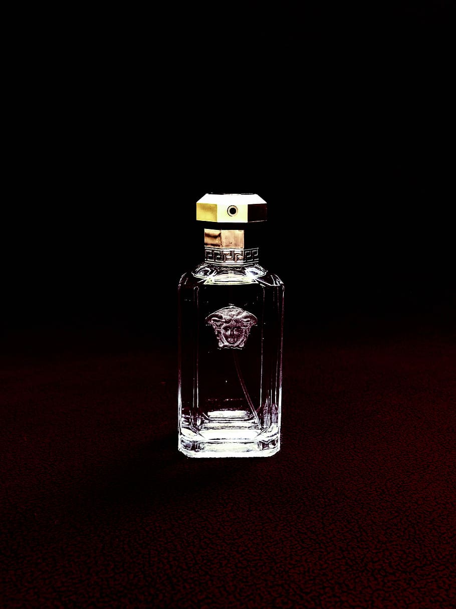 clear Versace glass fragrance bottle, low-light photo of Versace bottle HD wallpaper