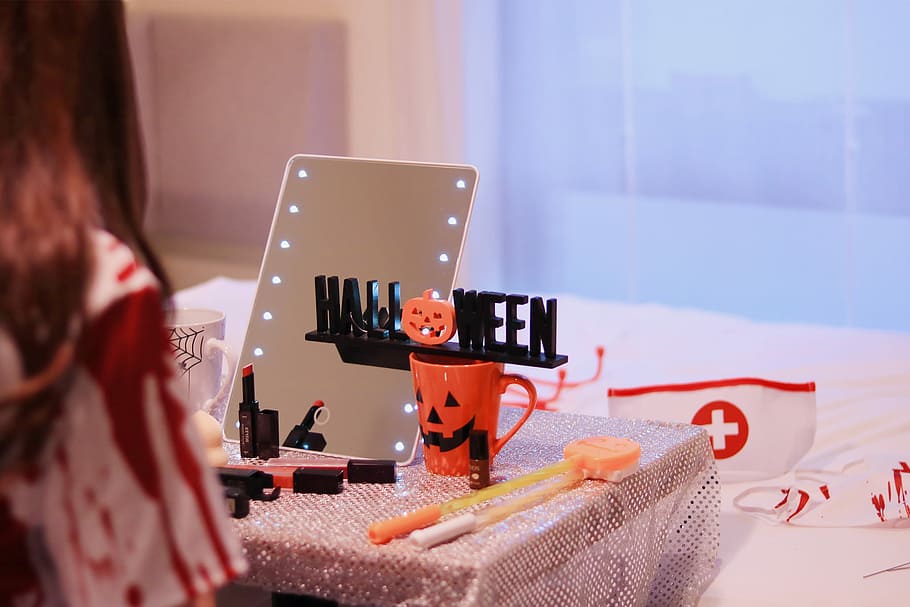 Halloween freestanding text on orange mug on table with table cloth HD wallpaper