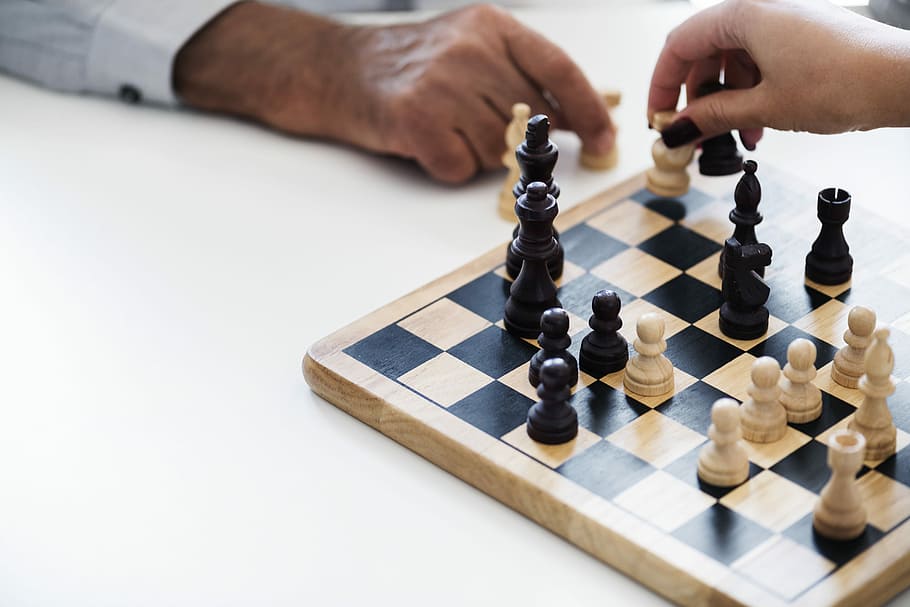 two person playing chess on white table, hands, chess piece HD wallpaper