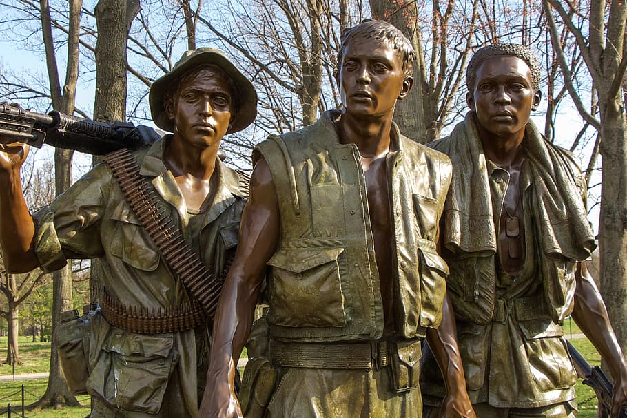 three military statues behind brown bare trees at daytime, vietnam memorial