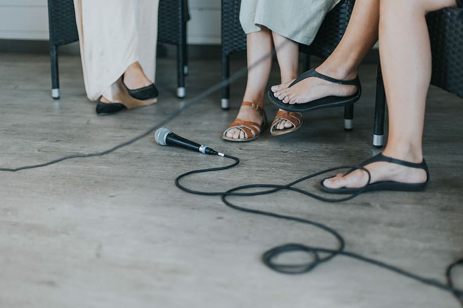 black microphone on floor, three people sitting on chairs near microphone HD wallpaper