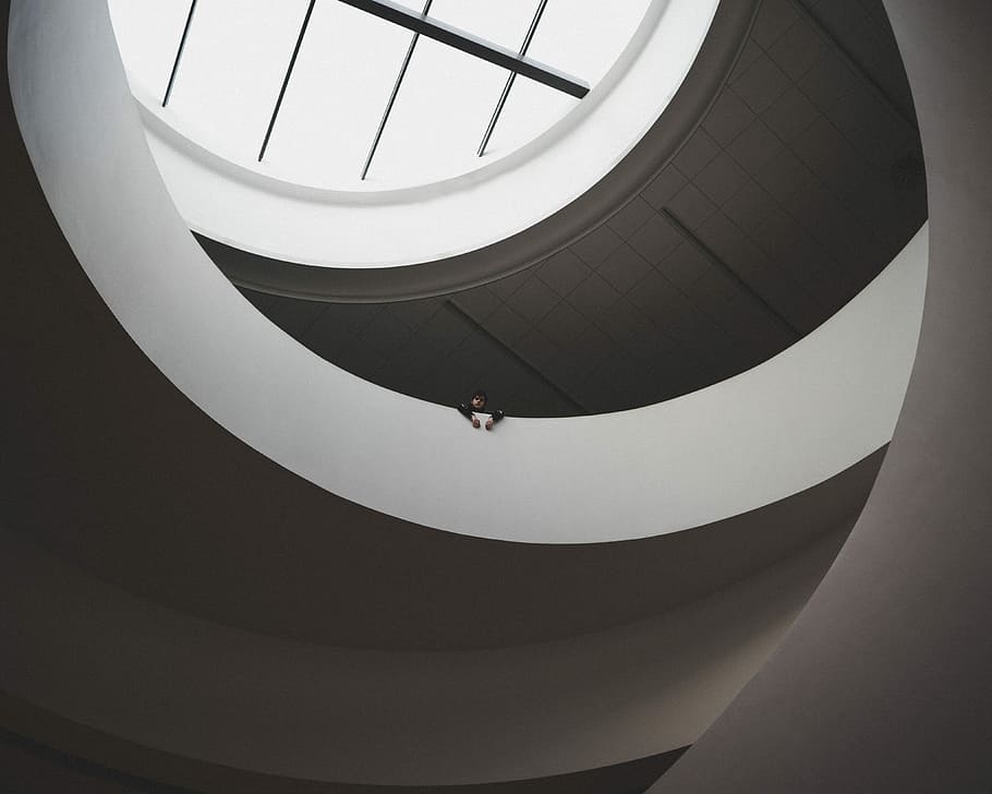 architectural photography of white and gray building, high angle view photography of person on top of white concrete floor HD wallpaper