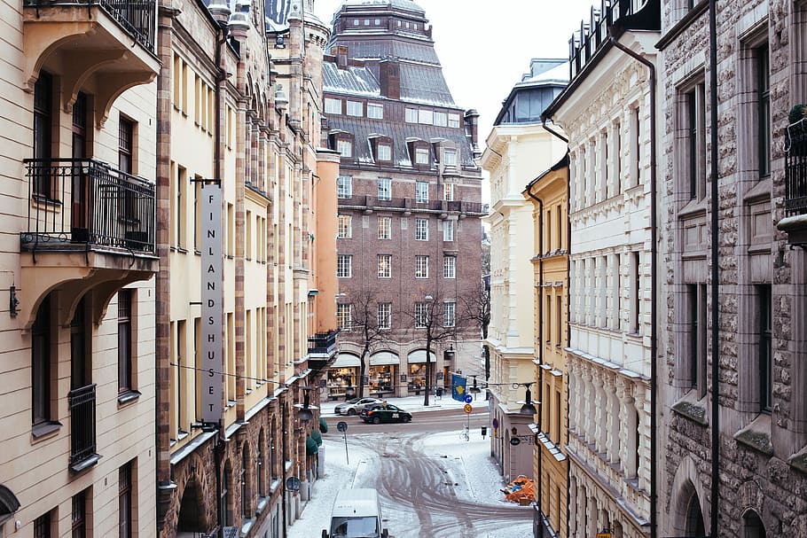 beige and black Finland Sunset building, two building with snow during daytime HD wallpaper