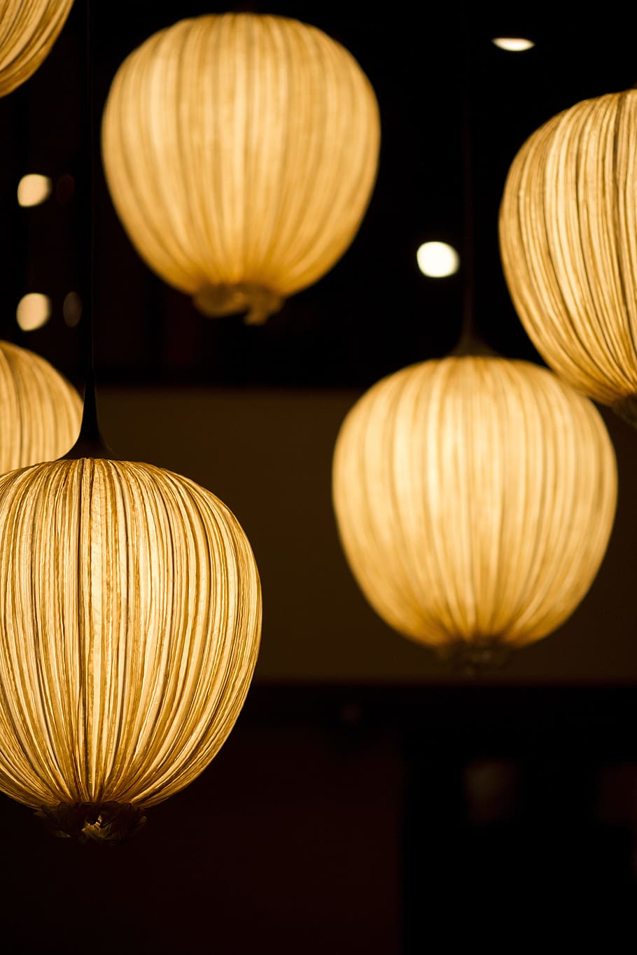 lighted round yellow lanterns in selective focus photography