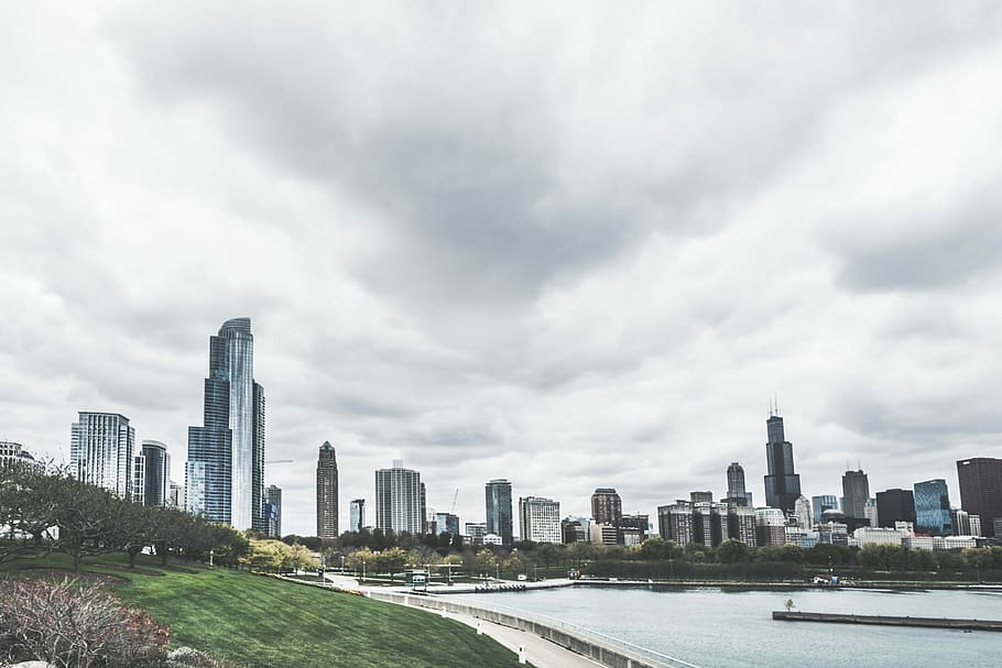 assorted high-rise buildings, city buildings near body of water at daytime HD wallpaper