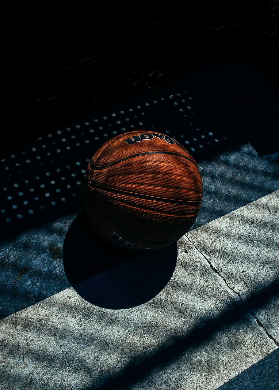 red basketball, red Wilson basketball ball, court, shadow, sunlight