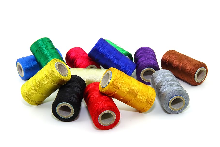 photograph of assorted-color thread spool lot, threads, bobbin
