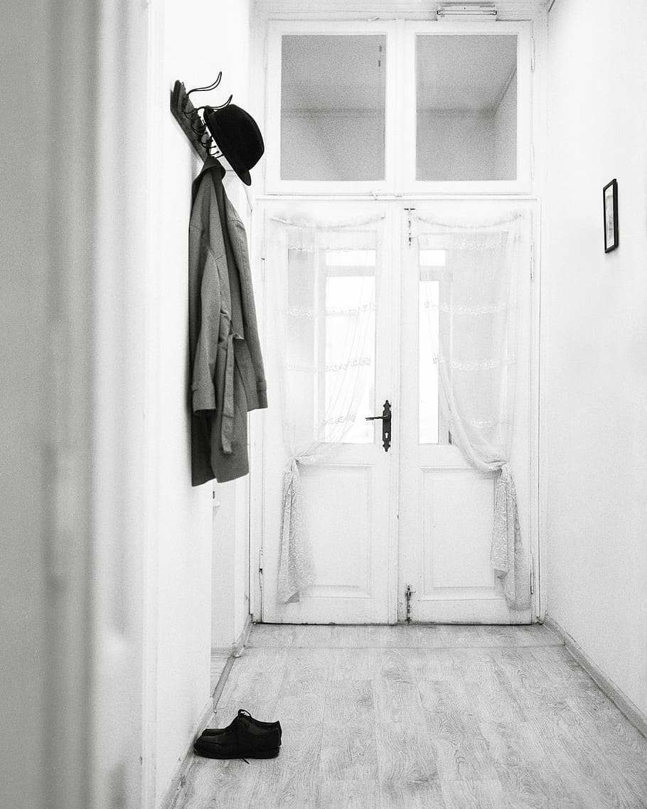 coat hanged on wall hooks, grascale photography of coat and hat handed on the wall at the corridor HD wallpaper