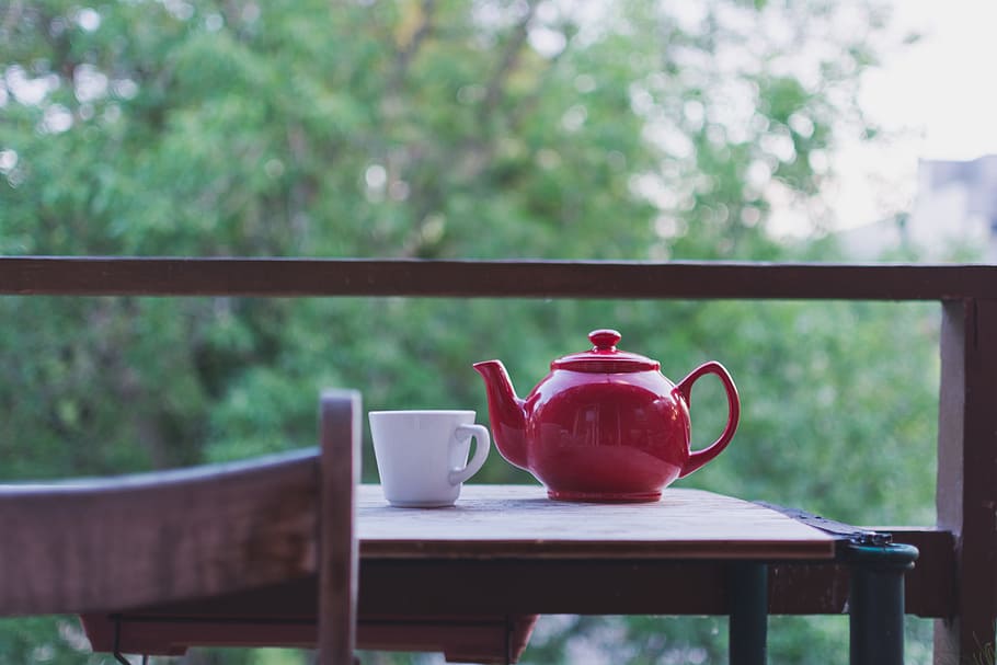 red ceramic teapot near white ceramic mug on brown wooden table, HD wallpaper