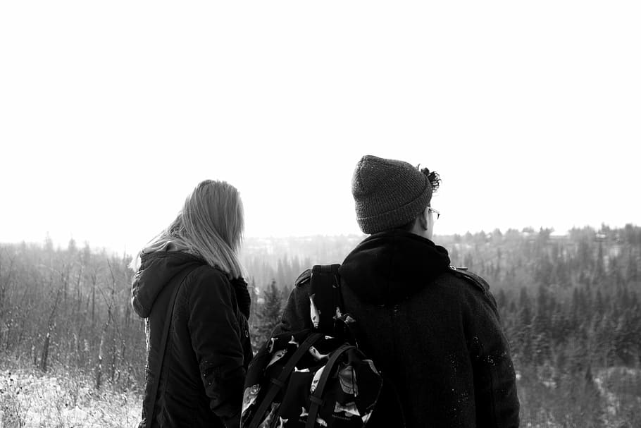 man and woman standing on fields, grayscale, photo, coat, overlooking
