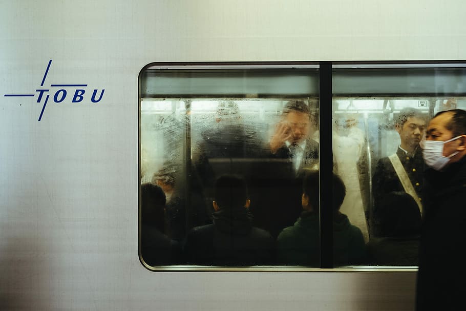 man beside gray train, man wearing black jacket with white mouth mask walking near train HD wallpaper