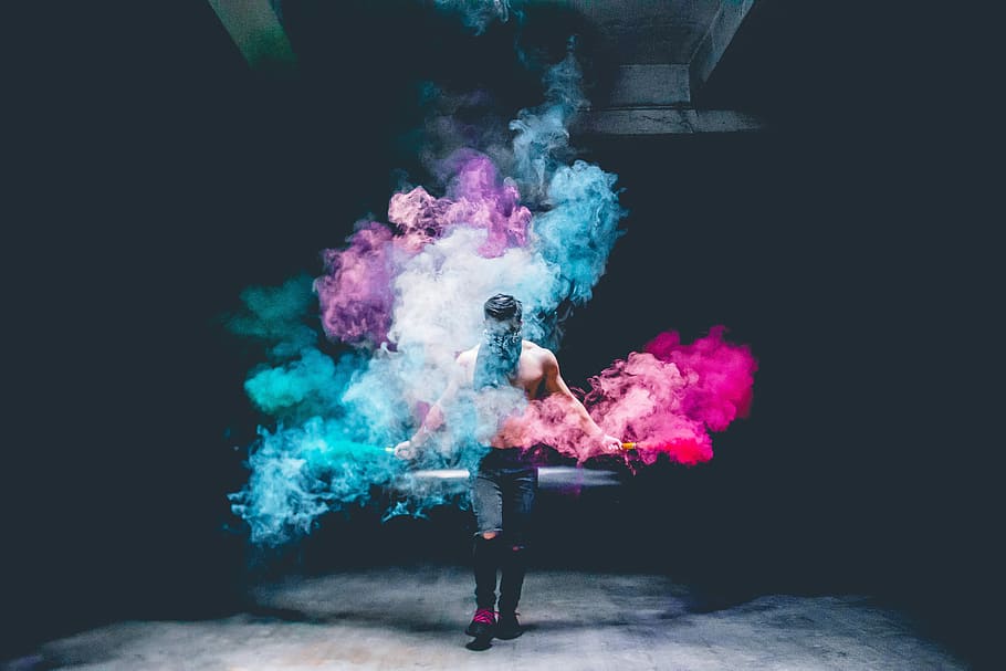 God Season, photo of man surrounded by colored powder, smoke