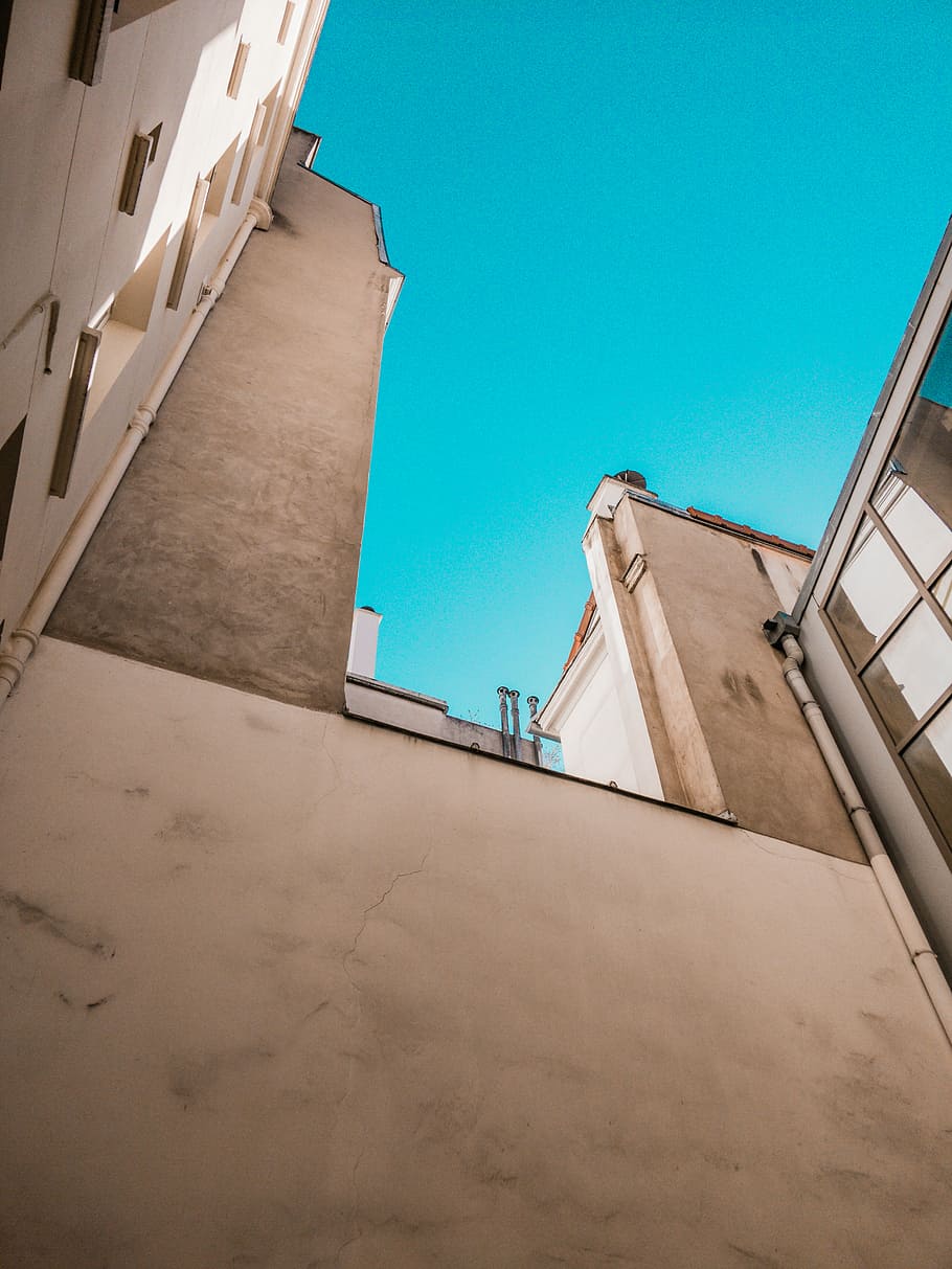 low angle photograph of white concrete structures, beige concrete building HD wallpaper