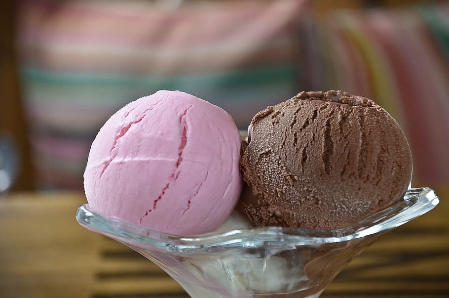selective focus photography of two strawberry and chocolate ice cream scoops