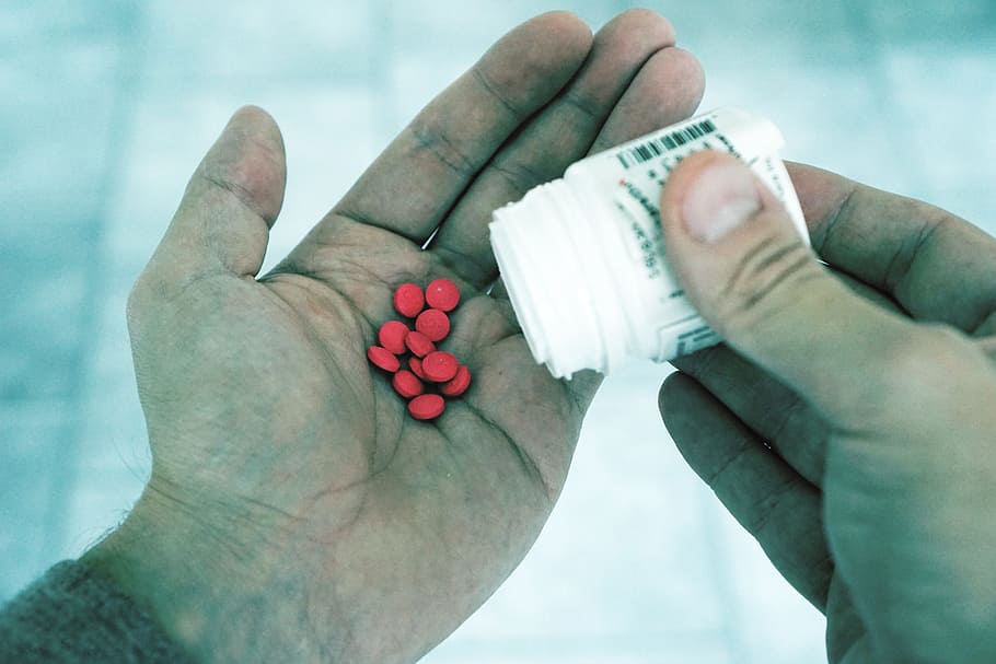 man holding white plastic tablet bottles, pills, medicine, tablets HD wallpaper