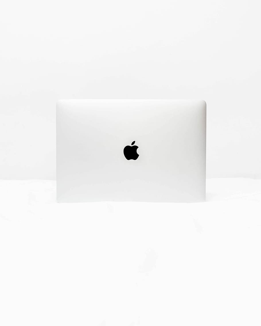MacBook White open on white surface, silver Apple MacBook on white surface