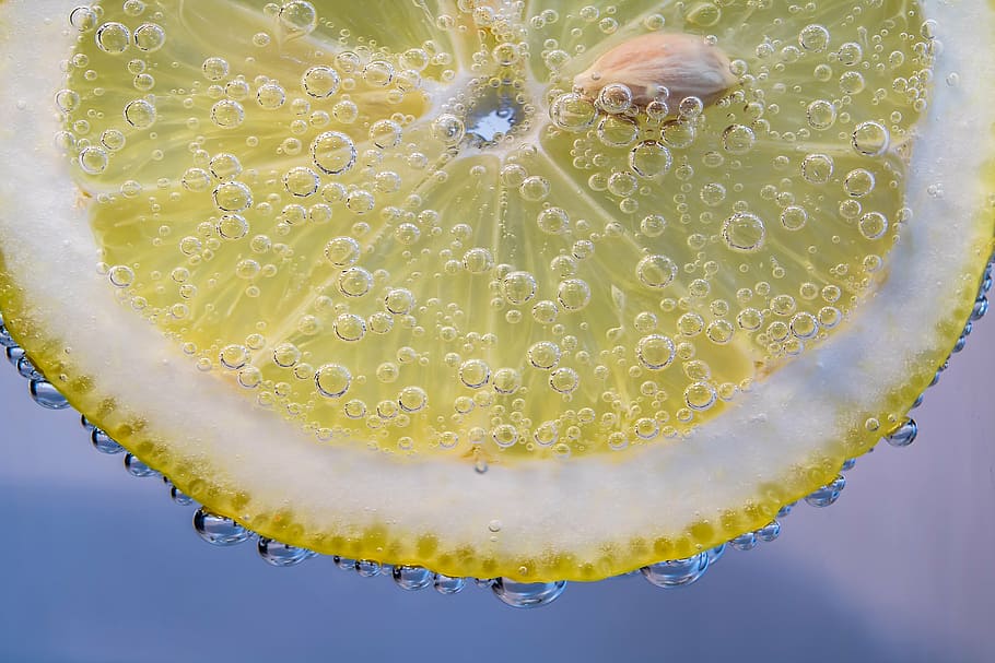 macro photography of sliced lemon in carbonated drink, slice of lemon