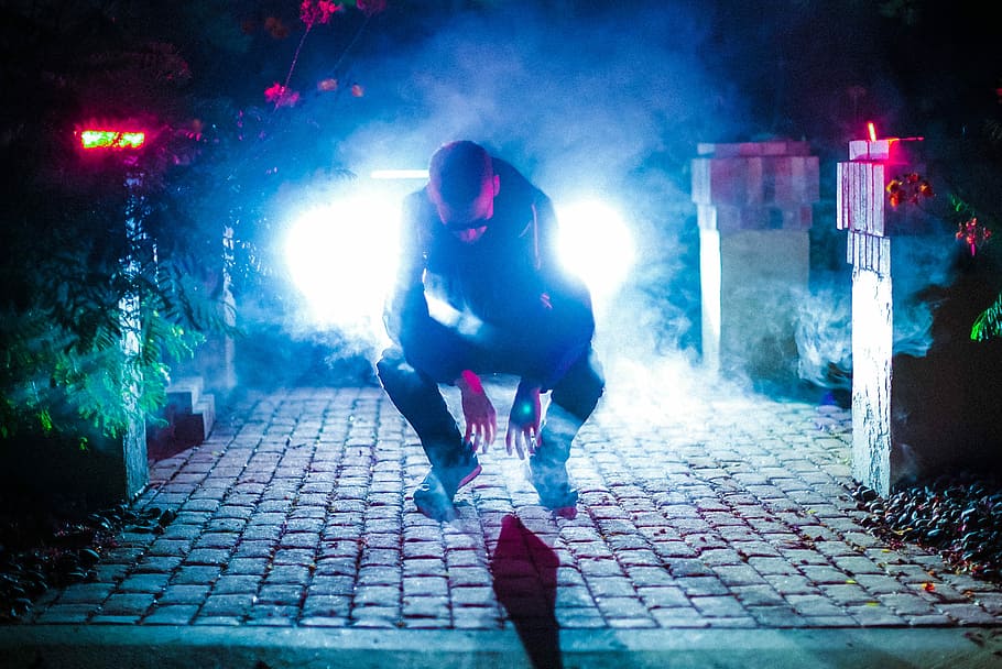 Colors Illuminated, man sitting on floor near posts, portrait HD wallpaper