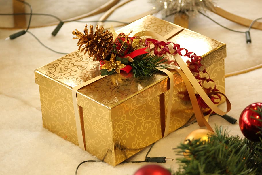 gold-colored floral gift box on beige surface, christmas, packed HD wallpaper