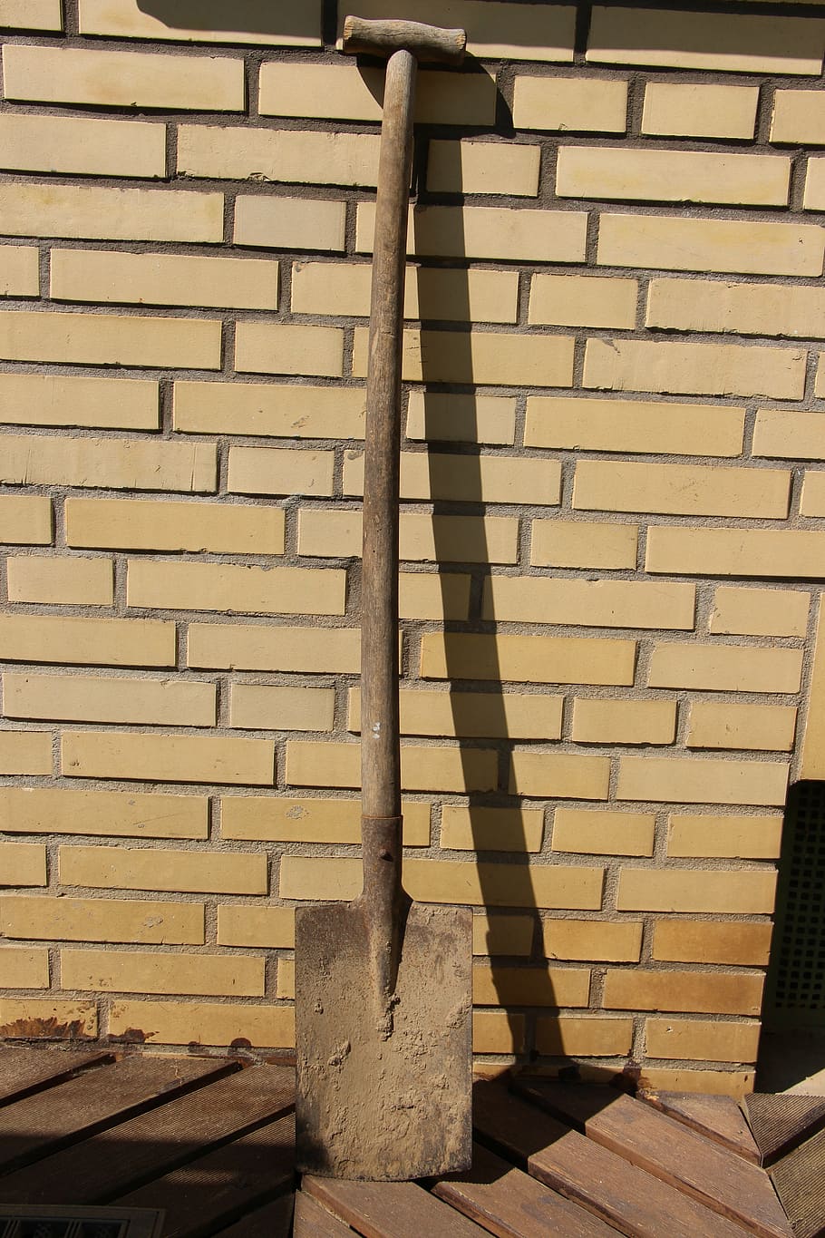 brown shovel, blade, spade, beige, wall, stone wall, work, dirty