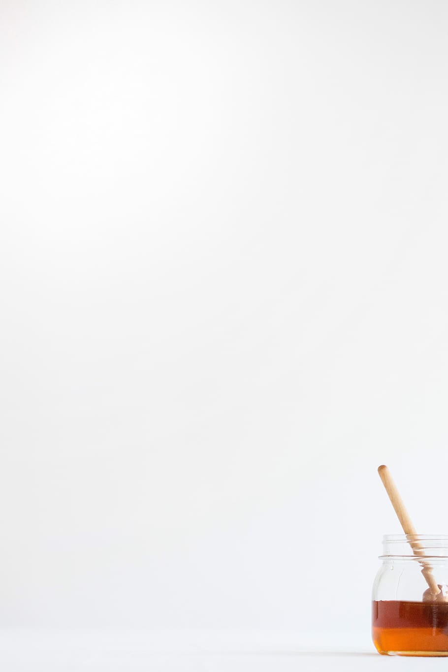 Minimal, honey in jar with brown wooden stick, white, spoon, studio shot HD wallpaper