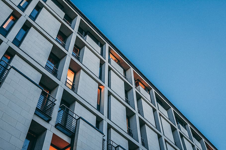 low angle photography of gray high rise building at daytime HD wallpaper
