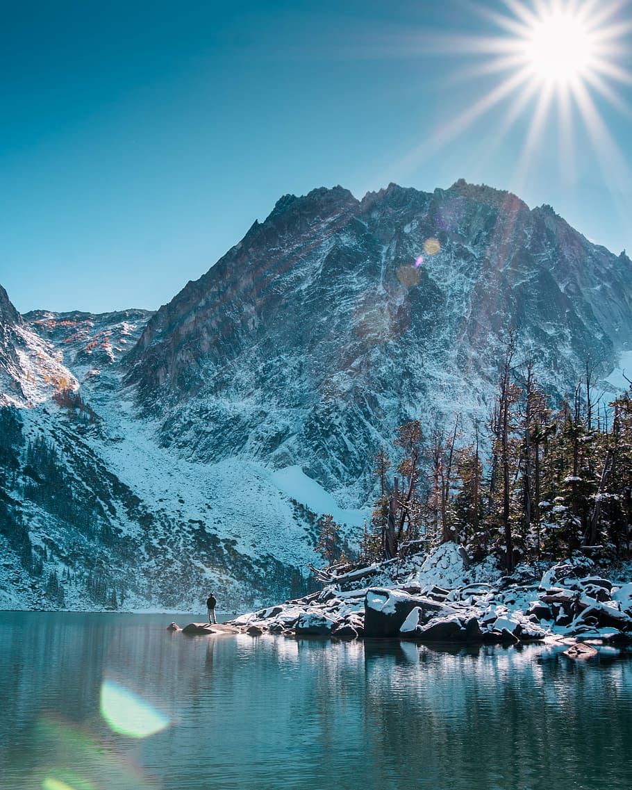 man standing beside of the lake, landscape photography of mountain HD wallpaper