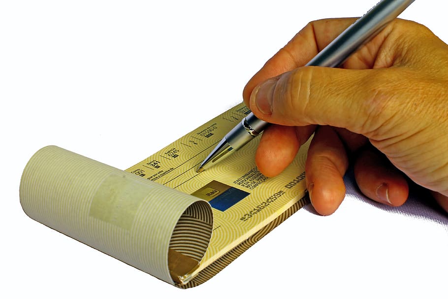 person holding black ball-point pen, checkbook, coupon, fill HD wallpaper