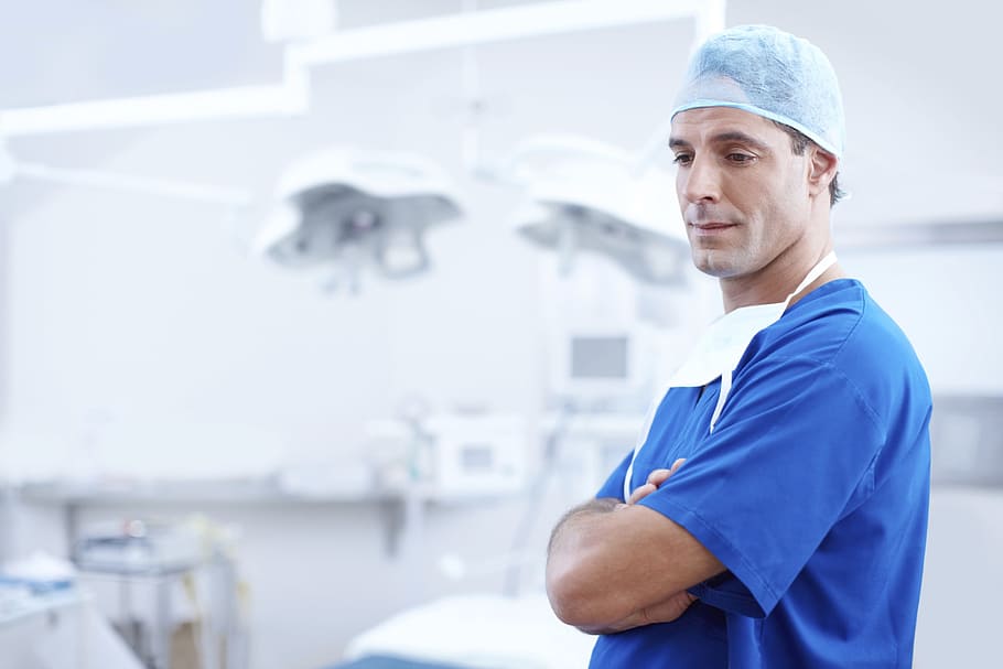 man wearing blue nursing scrub top, male, doctor, operating room