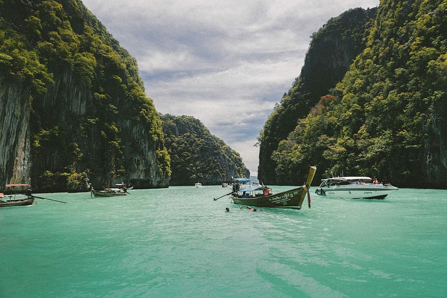 four wooden boat on teal sea, Ha Long Bay, Vietnman, island, tropical