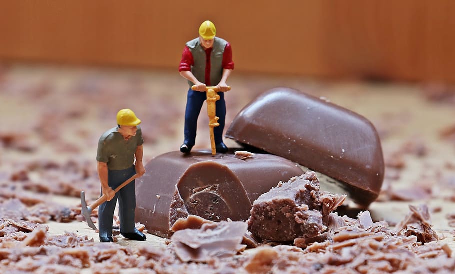 two construction men hammering chocolate bar mini figures, miniature figure