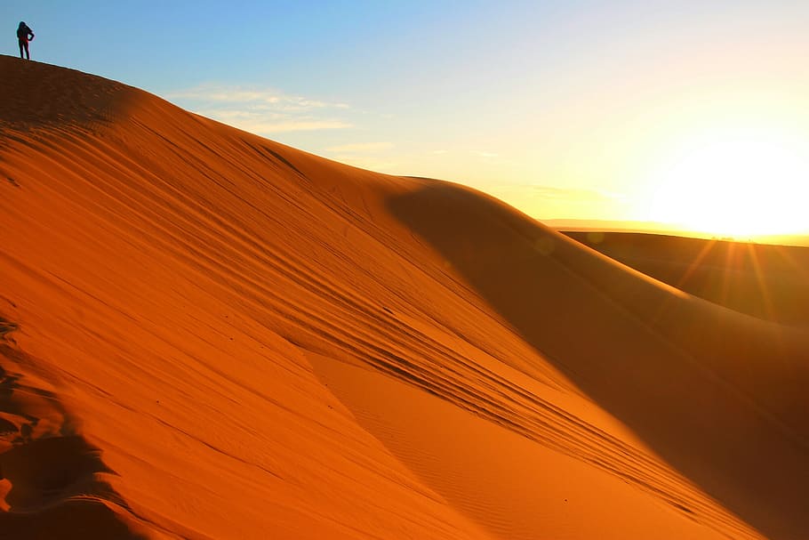 person standing on top of desert mountain during daytime, alone HD wallpaper