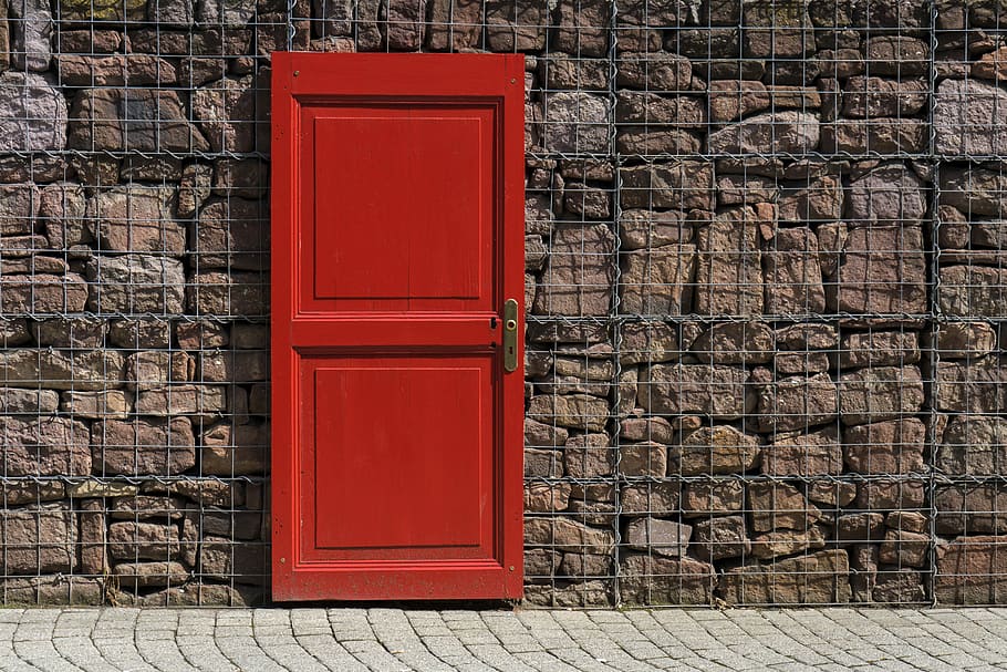 red 2-panel door on black metal chain link board, closed red door HD wallpaper
