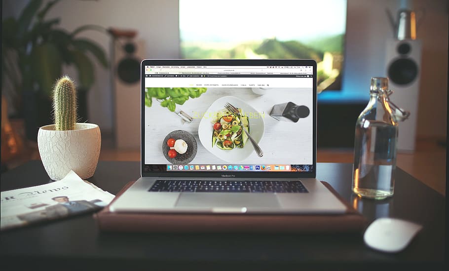 MacBook Pro beside clear glass bottle, laptop, apple, computer HD wallpaper